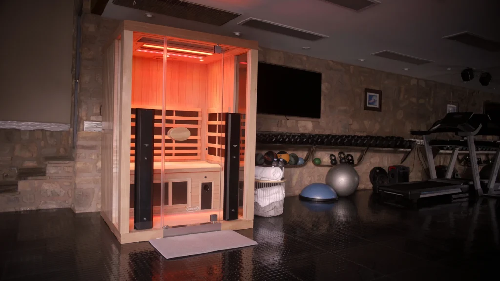 Lit Jacuzzi Sauna in workout room.